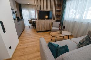 a living room with a couch and a table at Winkler Appartements in Saalbach Hinterglemm