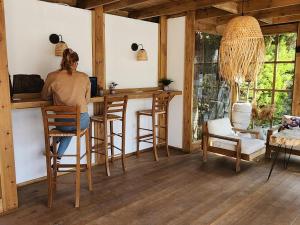 a woman sitting at a bar in a room at Costa Bodrum City in Bodrum City