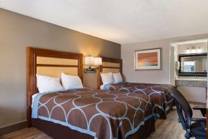 a hotel room with a bed and a mirror at Rodeway Inn Charlotte Airport Area in Charlotte