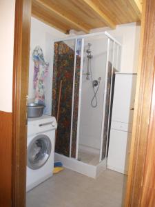 a laundry room with a washing machine and a shower at Tourist Rental Home ROMA in Rome