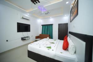 a hotel room with a bed and a tv at THE HOTEL PARADISE in Gorakhpur