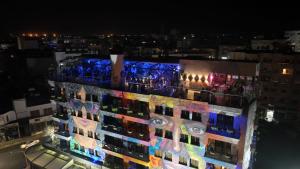 a building with lights on the side of it at night at Rise Street Art Hotel in Larnaka
