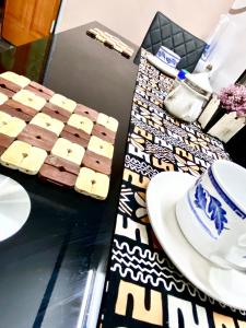 a table with a tray of chocolate and a plate of food at Deluxe résidence in Ouagadougou