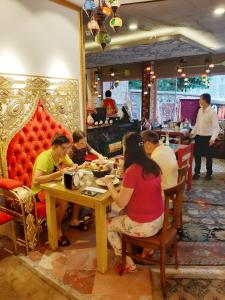 a group of people sitting at a table in a restaurant at Elasophia Hotel in Istanbul