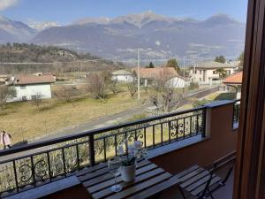 a balcony with a table and a view of mountains at Casa Lory in Colico
