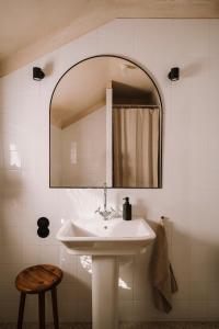 a white bathroom with a sink and a mirror at Gniazdowo nad rzeką - dom z sauną i masażem in Łochów +48 photos