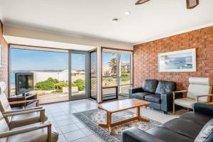 a living room with a couch and a table at Beachfront Views at Southern Sands 1 in Port Elliot