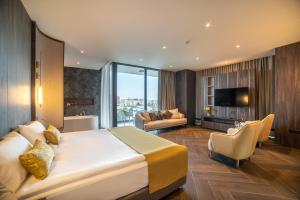 a bedroom with a large bed and a living room at Hotel Pia Bella in Kyrenia