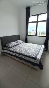 a bed sitting in a room with a window at Grand View House GVH in Bandar Penawar