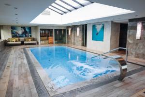 a large swimming pool in a hotel room with at Van der Valk Hotel Oostzaan - Amsterdam in Oostzaan