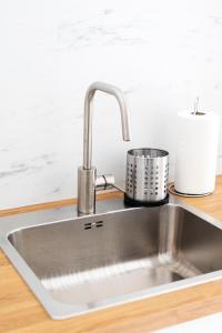 a stainless steel kitchen sink on a counter at Maya's Flats & Resorts 18 - Nadmotlawie in Gdańsk