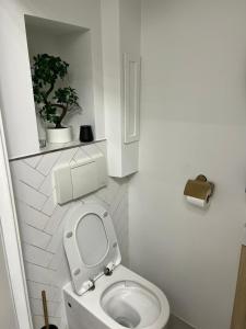a bathroom with a toilet with the seat up at Central Suite Rotterdam in Rotterdam