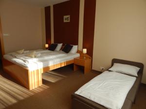 Dos camas en una habitación de hotel con sidx sidx sidx sidx sidx en Panorama Hotel Noszvaj, en Noszvaj