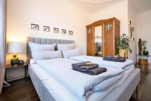 two beds with towels on them in a bedroom at EXKLUSIV home & business Deluxe Kregel Apartment 70qm in Leipzig