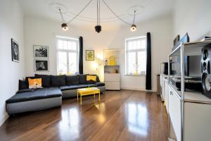 a living room with a couch and a table at EXKLUSIV home & business Deluxe Kregel Apartment 70qm in Leipzig