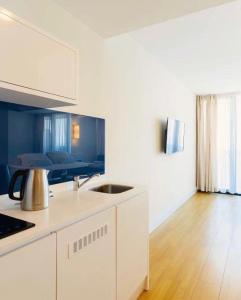 a kitchen with a sink and a counter top at Batumi Rest Apartament in Batumi