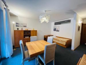 a dining room with a table and chairs and a bed at San Luigi - Rooms & Apartments in Campodolcino