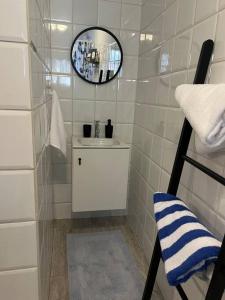 a white bathroom with a sink and a mirror at Romantic place savaneta near several beaches in Savaneta