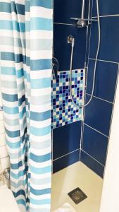 a bathroom with a shower with blue and white tiles at Capri Suite on the beach in Capri +34 photos