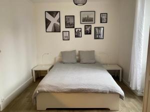 una camera da letto con un letto con due tavoli e quadri appesi al muro di Park Avenue a Orléans