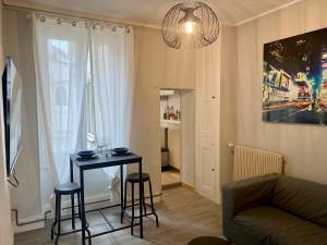 a living room with a table and two stools at Park Avenue in Orléans