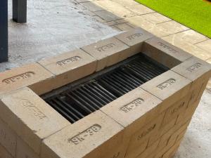 a box with a grate in the middle of a sidewalk at 寧靜的家B區10人Vila獨立設施包棟戲水池烤肉區麻煩廚房洗衣機 in Hengchun