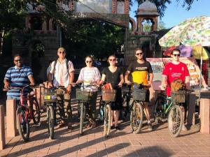 a group of people posing with their bikes at Zigzag Homestay in Agra