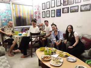 a group of people sitting in a living room at Zigzag Homestay in Agra