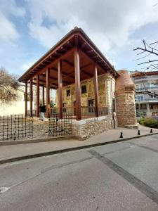 a pavilion with a stone building on the side of a street at Φιλοξενία1 in Drama