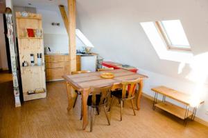 a kitchen with a wooden table and some chairs at Gite Staufen in Thann