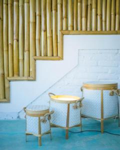 two tables in front of a wall with pipes at Guru Canggu in Canggu