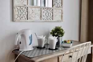 a table with a coffee maker on top of it at Hostal Tres Soles in Nerja