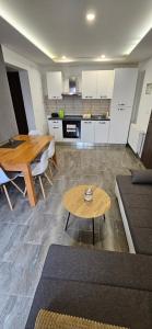 a living room with a table and a kitchen at Apartmani KA Sveti Martin in Sveti Martin na Muri