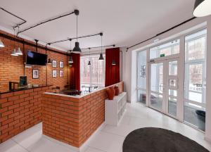 a room with a brick wall and a bar at HELLO INN budget hotel in Astana