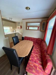 ein Wohnzimmer mit einem Tisch und einem Sofa in der Unterkunft Le Murmont in Thonnance-lès-Joinville