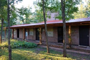 a brick building with trees in front of it at Santa Mate in Nono