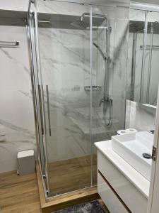 a bathroom with a shower and a sink at NAFPAKTOS-luxury suite in Nafpaktos