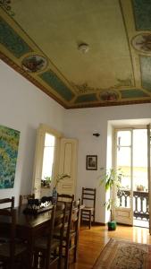 a dining room with a table and chairs and a ceiling at Al Porta Susa B&B in Turin