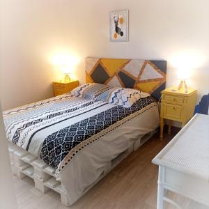 een slaapkamer met een groot bed met 2 nachtkastjes bij Domaine des deux A in Margny-sur-Matz