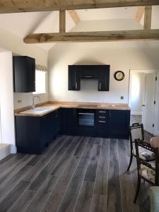 a kitchen with blue cabinets and a counter top at The Stables in Colchester