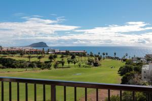 a view of the ocean from a balcony of a resort at Golf View Apartment - stunning ocean view Golf del Sur in San Miguel de Abona