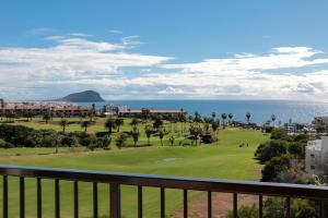 a view of the ocean from a balcony of a resort at Golf View Apartment - stunning ocean view Golf del Sur in San Miguel de Abona