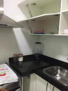 a kitchen with a sink and a counter top at Golden Lake - Vista Lagoa in Arraial do Cabo +12 photos