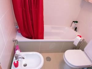 a bathroom with a sink and a red shower curtain at AL - Amar Odeceixe in Odeceixe