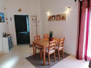 a dining room with a wooden table and chairs at AL - Amar Odeceixe in Odeceixe