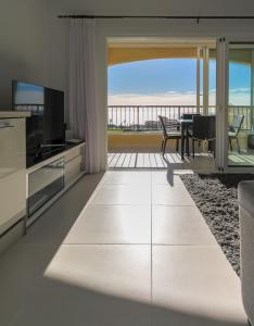 a living room with a view of the ocean at Golf View Apartment - stunning ocean view Golf del Sur in San Miguel de Abona