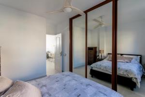 a bedroom with a mirror and a bed in it at Golf View Apartment - stunning ocean view Golf del Sur in San Miguel de Abona