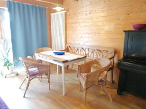 a dining room with a table and chairs and a piano at Hof Idarwald in Horbruch