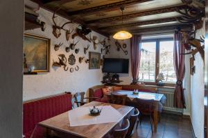 a restaurant with two tables and a tv on the wall at Hotel Bavaria in Inzell