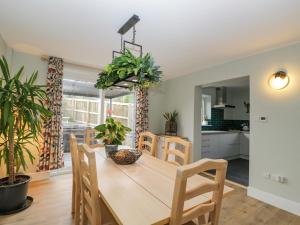 a kitchen and dining room with a table and chairs at Birch House in Corsham